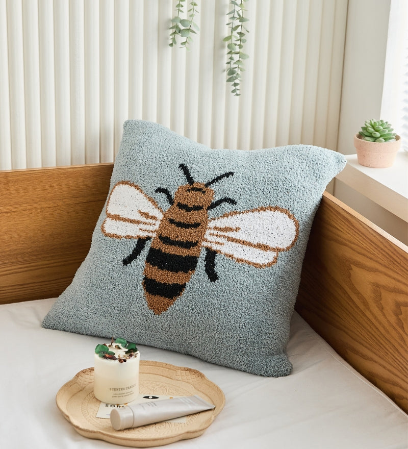 Coussin bleu ciel avec un motif d'abeille en Pilou